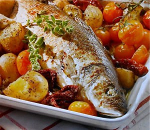 Baked sea bass with sun dried tomatoes, capers and potatoes